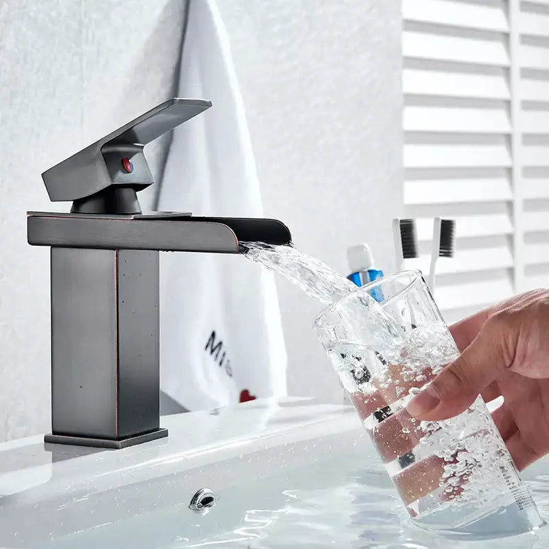 Modern matte black basin faucet mixer tap with sleek rectangular design and single red accent button for bathroom vessel sink