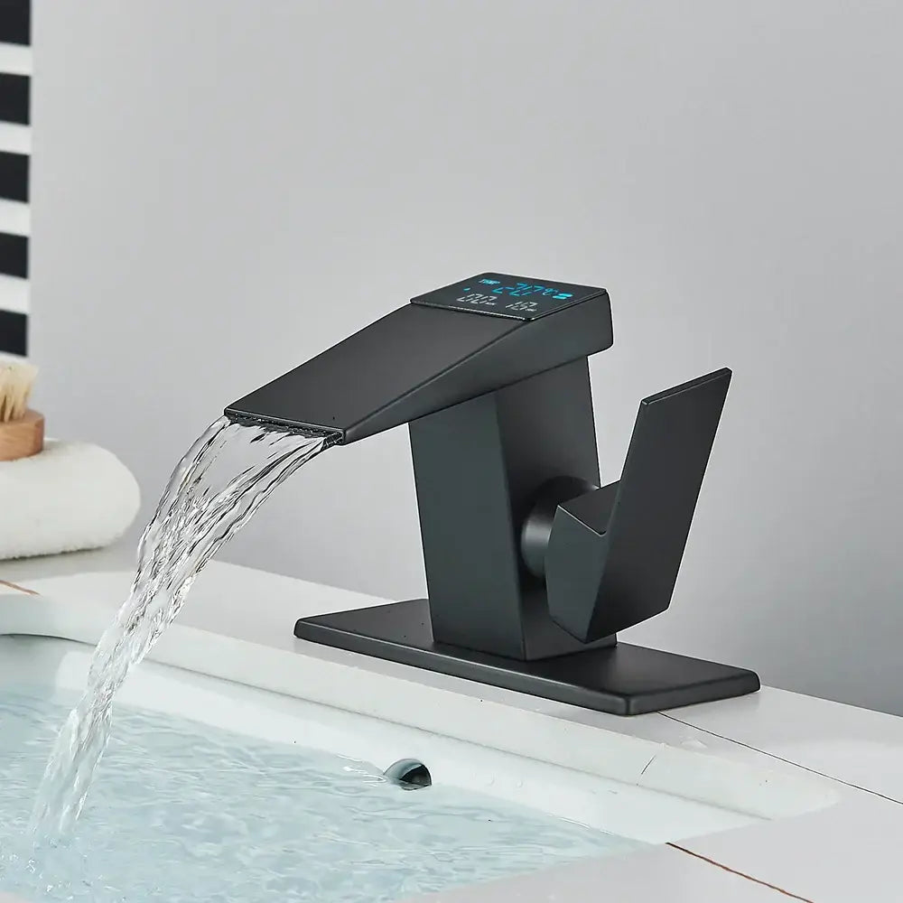 Modern matte black bathroom faucet with brass waterfall design and digital temperature display by decorbites