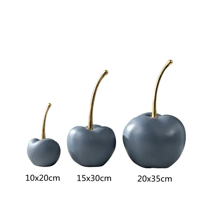 Set of three matte gray ceramic cherry figurines with gold-toned stems complement modern blue resin apple ornaments decor