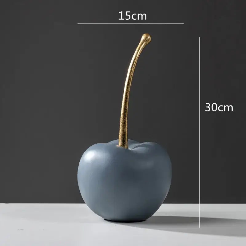 A sleek matte blue resin apple ornament with a slender gold stem for modern living room decor apple ornaments