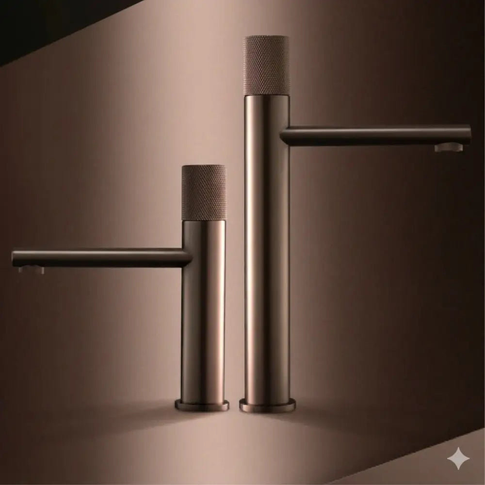Two modern matte bronze basin faucets with textured cylindrical handles and sleek minimalist design for kitchens