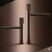 Two modern matte bronze basin faucets with textured cylindrical handles and sleek minimalist design for kitchens