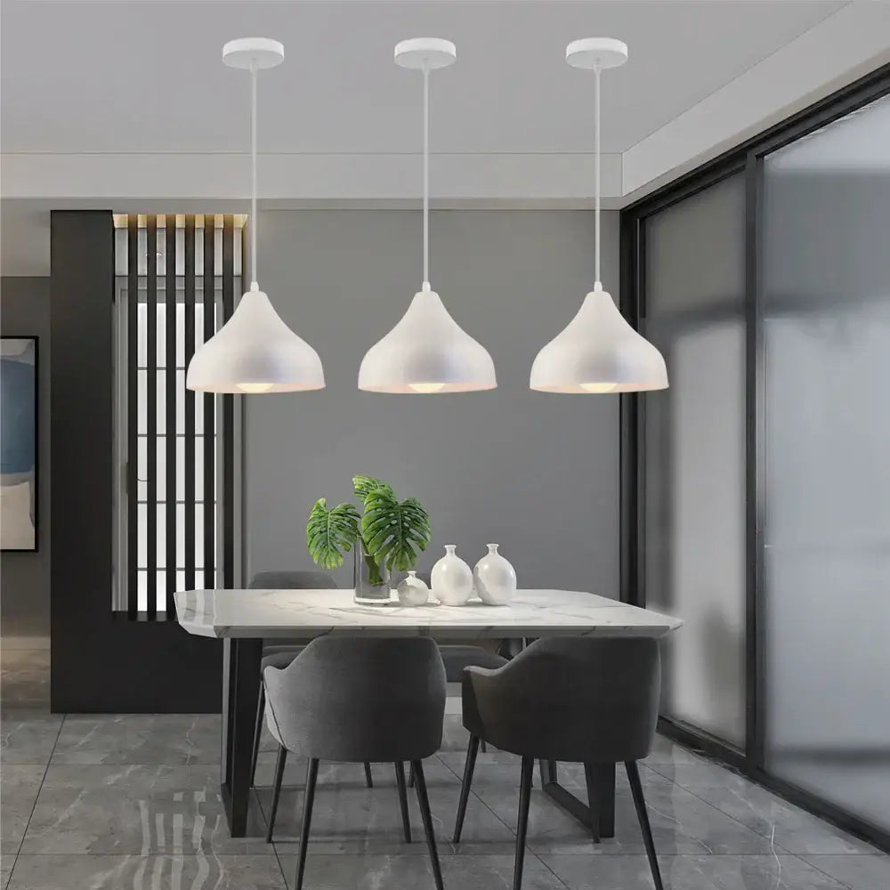 Three modern white matte pendant lights hanging above a dining table decorbites colorful nordic pendant light for kitchen
