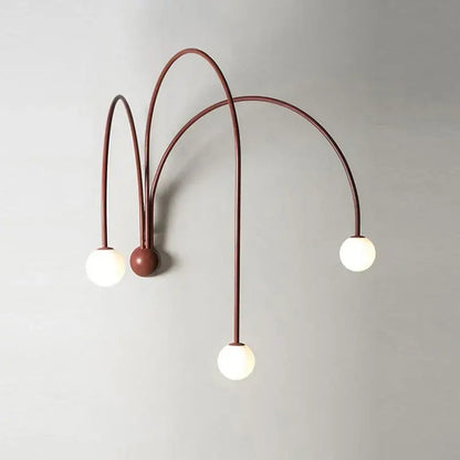 Modern matte copper wall lamp with three rust-colored metal arms and glass ball modern bulbs for living room decorbites
