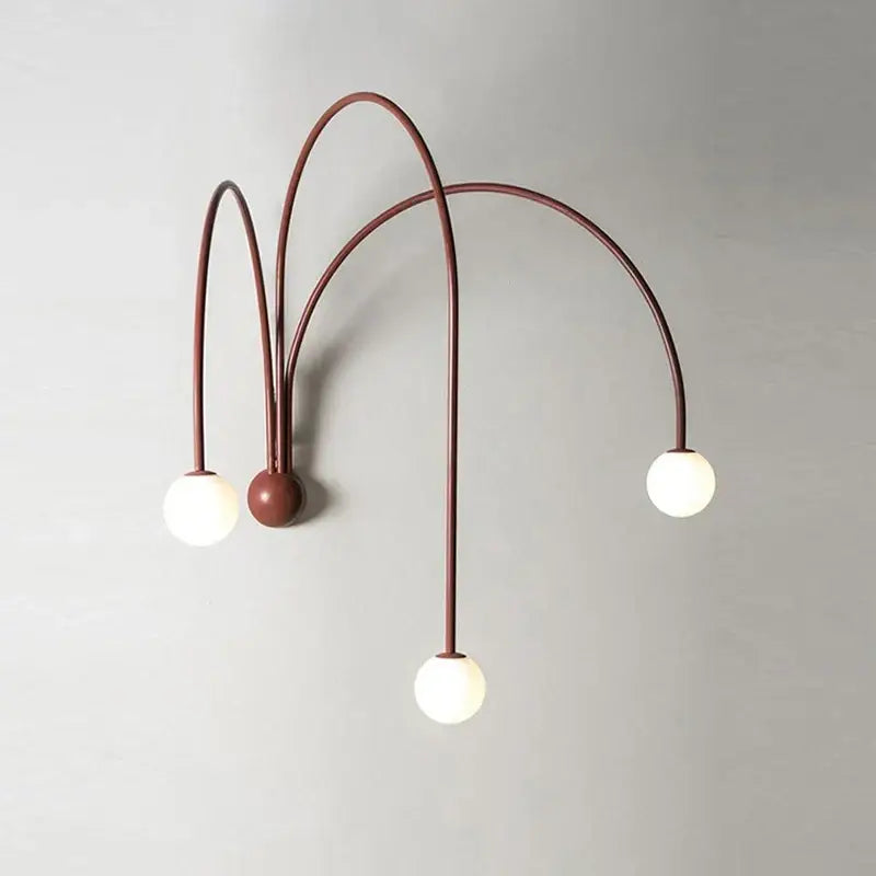 Modern matte copper wall lamp with three rust-colored metal arms and glass ball modern bulbs for living room decorbites