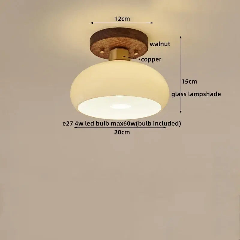 Rounded glass ceiling lamp with warm glow, mounted on walnut wood base and copper decorbites led wood canopy