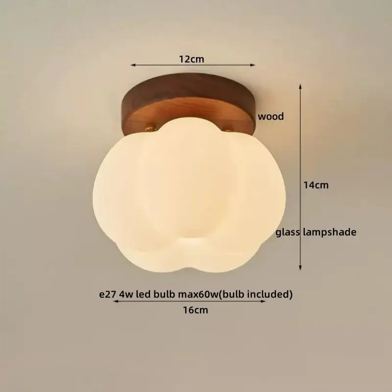A modern off-white glass ceiling lamp with a cloud-shaped shade and led wood canopy on a dark wood base by decorbites