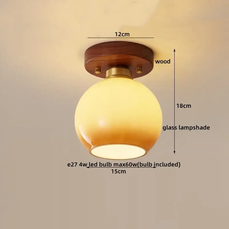 Modern matte dome ceiling lamp with warm-toned glass spherical shade, brass accents, and decorbites led wood canopy
