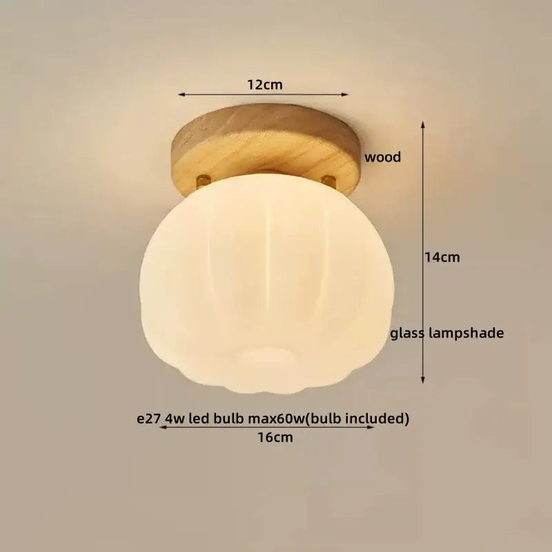 A warm glowing spherical glass ceiling lamp with subtle ribbed texture and decorbites led wood canopy base