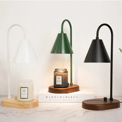 Modern matte green electric candle lamp warmer with wooden base and sleek curved metal arm for bedroom use