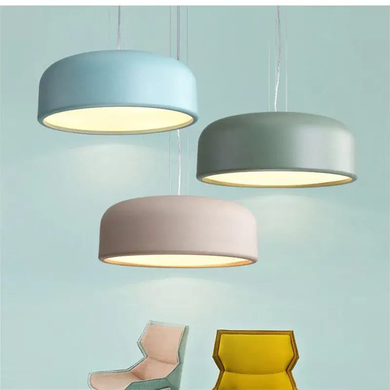 Three modern pendant lights with matte green cylindrical shades in a decorbites colorful macaron ceiling chandelier