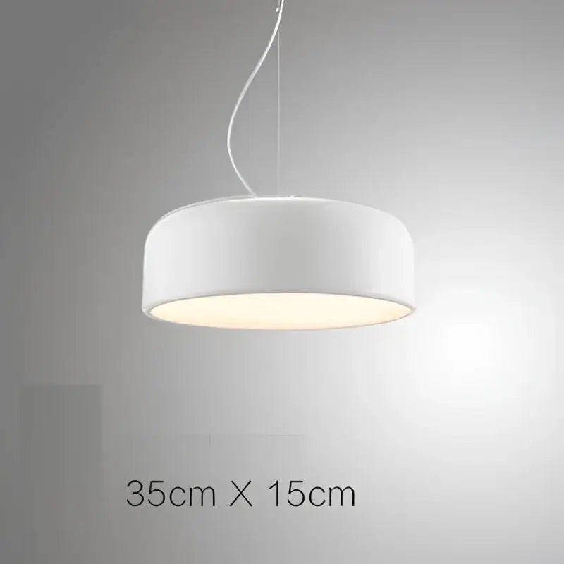 Modern matte green macaron ceiling chandelier with a white cylindrical pendant light and softly diffused warm glow for decorbites colorful macaron decor