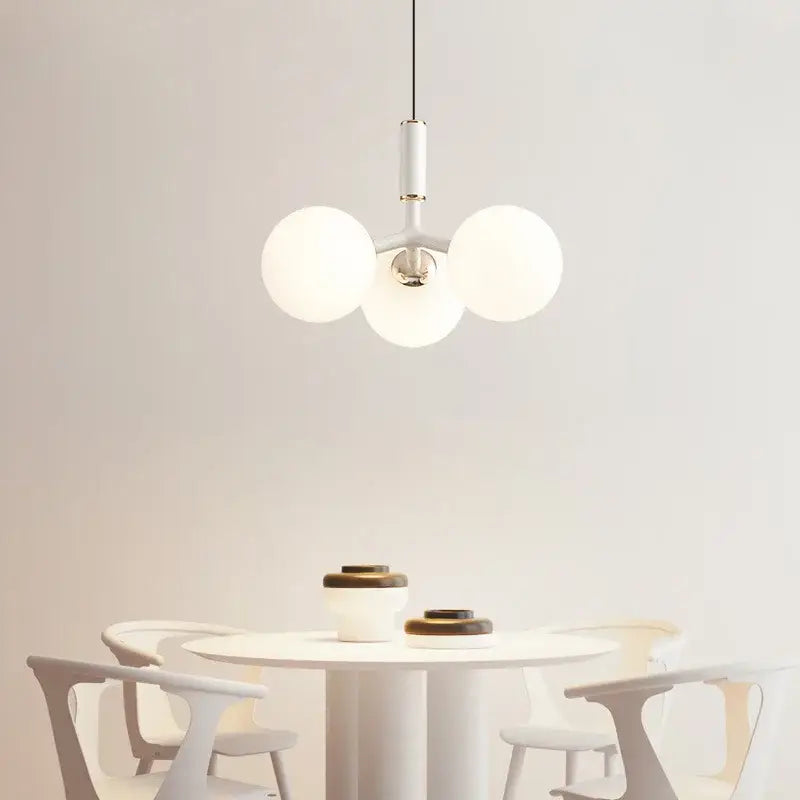 Minimalist white decorbites glass ball pendant lighting fixture with three frosted glass globes and metallic fixture