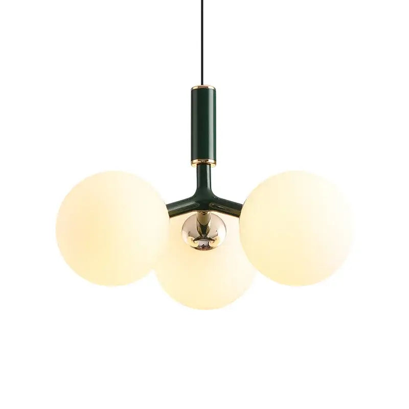 Modern three-bulb decorbites glass ball pendant lighting fixture with dark green metal frame and gold-toned accents for living room