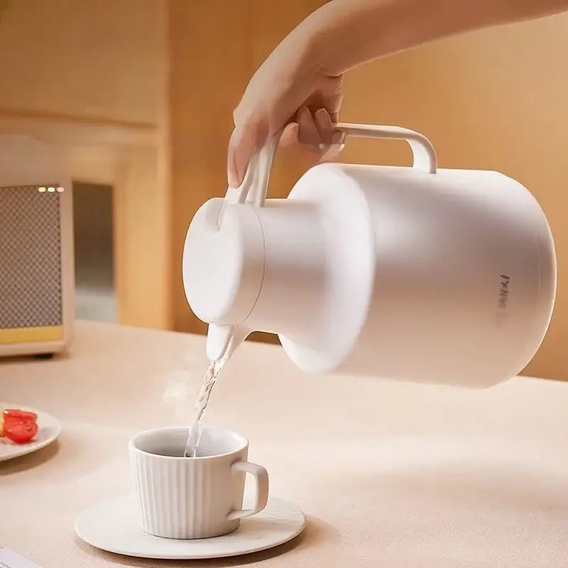 White ceramic electric kettle with curved handle and modern design for thermal insulation vacuum coffee use