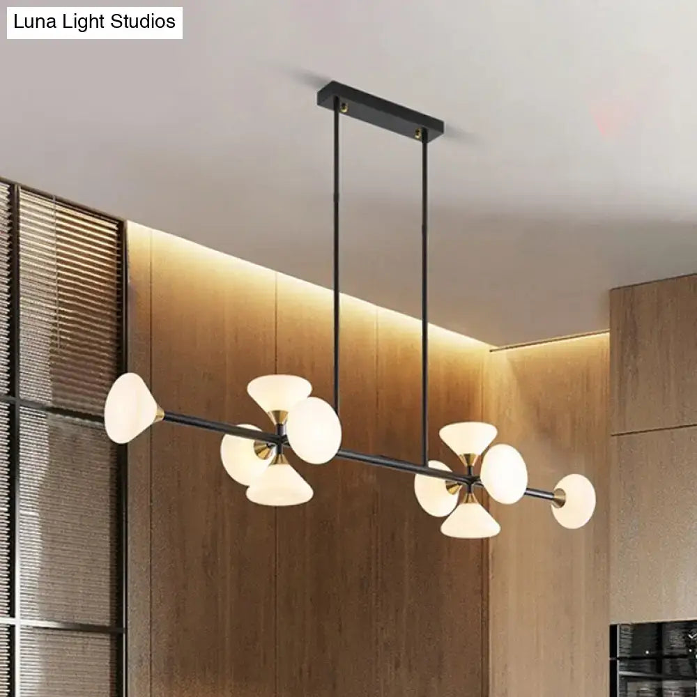 Modern black metal chandelier with frosted white glass flared shades and gold-toned accents for kitchen island lighting