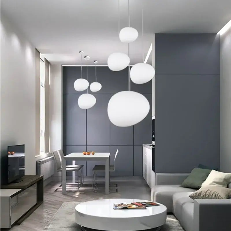 Modern matte white glass pendant light with spherical design hanging in dining room featuring decorbites gregg glass pendant light