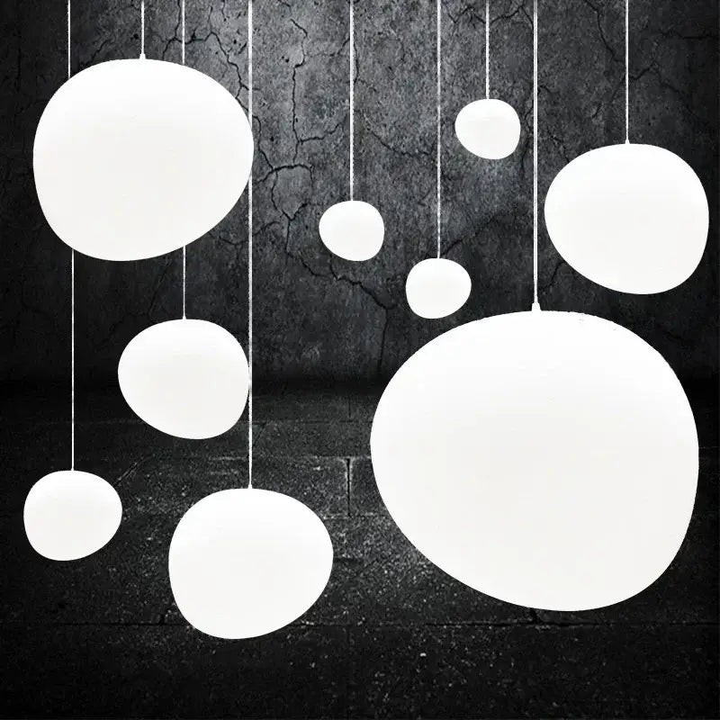 Modern matte white glass pendant light with smooth spherical shades hang at varying sizes for dining room decorbites gregg glass pendant