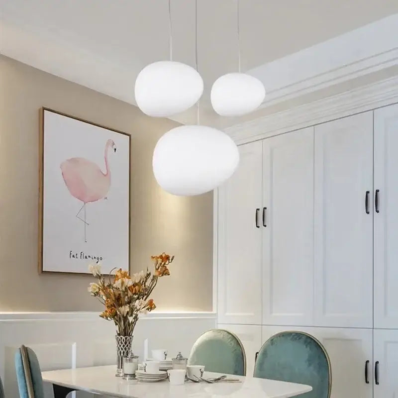 Three white oval-shaped matte glass pendant lights hanging from ceiling modern decorbites gregg glass pendant light