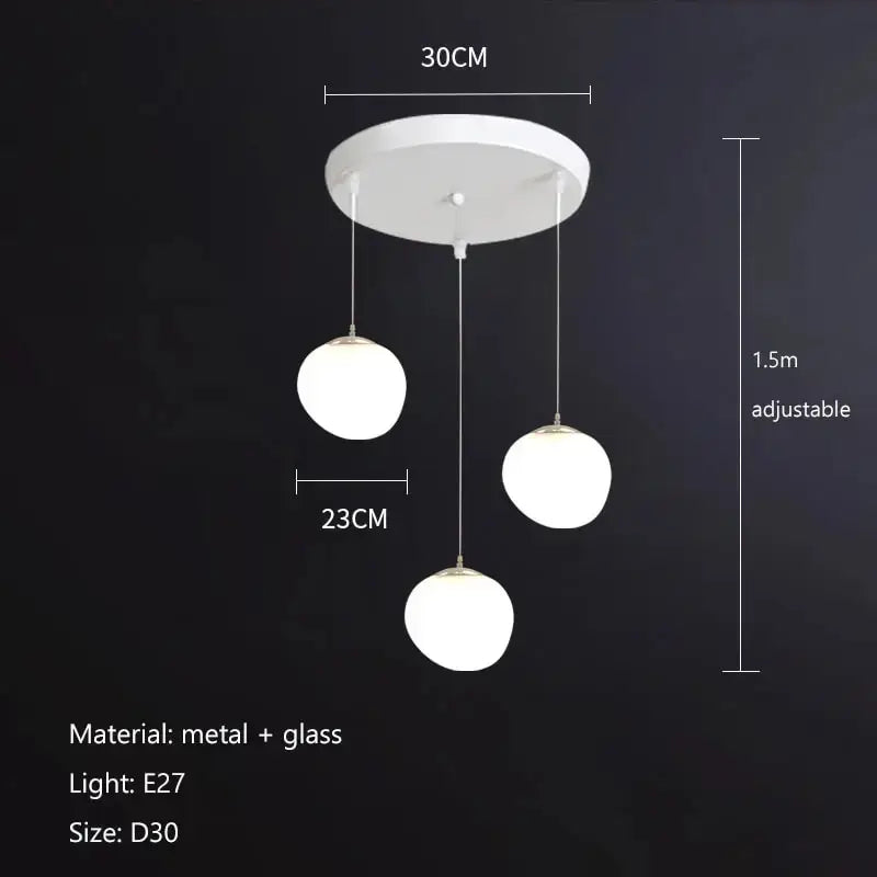 Modern matte white glass pendant light with three spherical globes and metal hardware for kitchen or dining decorbites gregg glass pendant