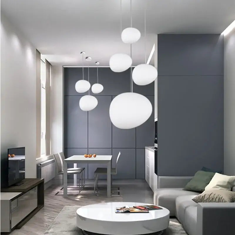 Modern matte white glass pendant light with spherical design hanging in minimalist kitchen and dining room decorbites gregg glass pendant