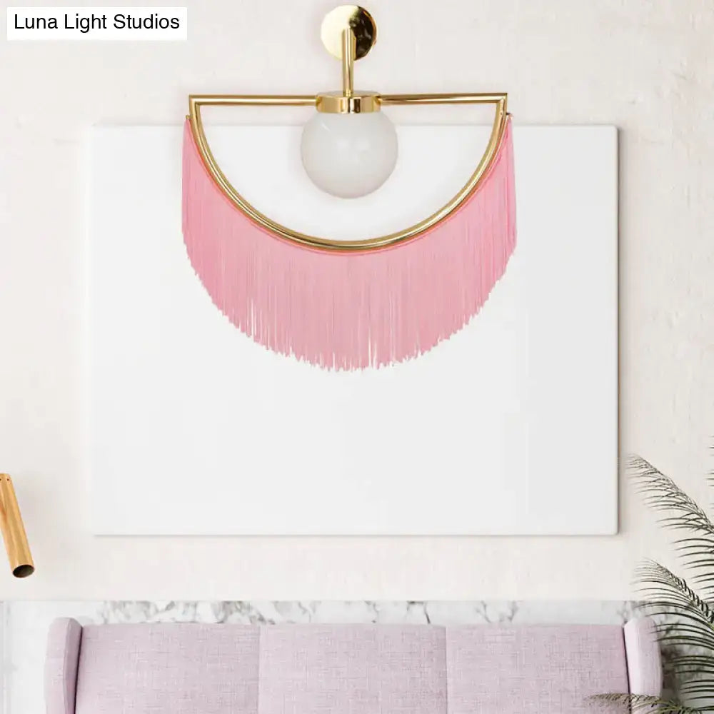 Modern matte white glass wall light with gold metal frame frosted globe and pink tassel fringe for bedroom use