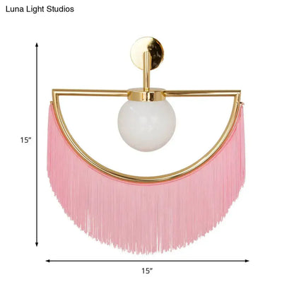 Modern matte white glass wall light with pink fringe tassel sconce and gold-toned metal frame wall light