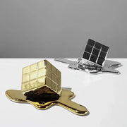 Modern melting geometric gold resin cube living room sculpture with a glossy, reflective surface and gold resin cube design