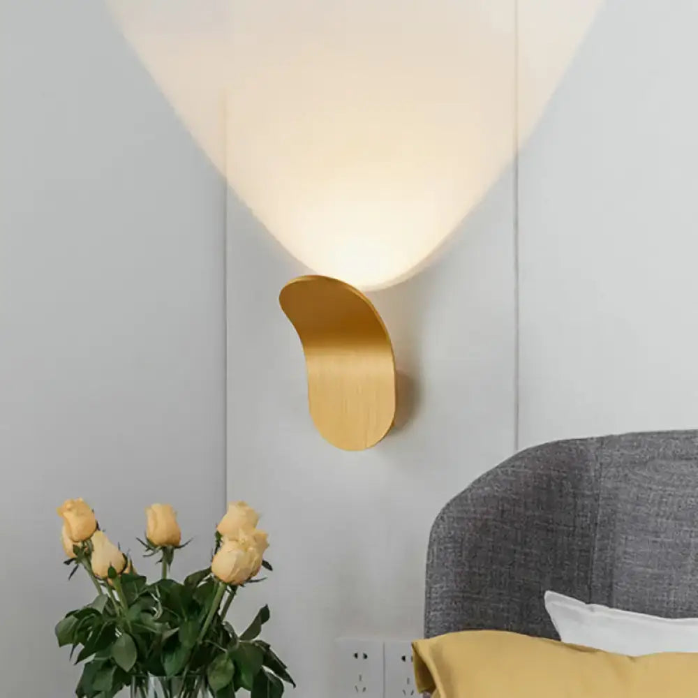Gold-toned minimalist wall light with metal bracket in black gold coffee finish featuring curved design and soft lighting