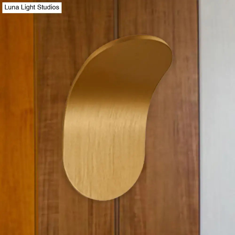 A sleek brushed gold metal bracket wall light with a curved leaf design in black gold coffee finish for bedroom use