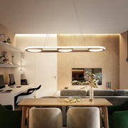 Modern metal white oval pendant light with three circular LED bulbs and sleek frame for kitchen island lighting