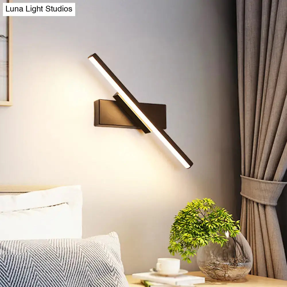 Modern metallic black linear vanity wall sconce with sleek angular design and warm LED light for bathroom use