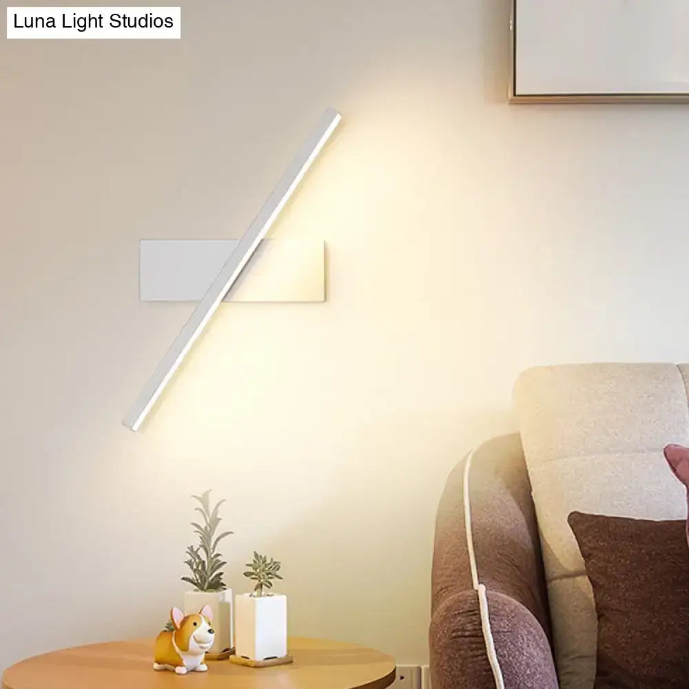 Modern metallic black and white linear vanity wall sconce with sleek angular design and warm white led ambient light
