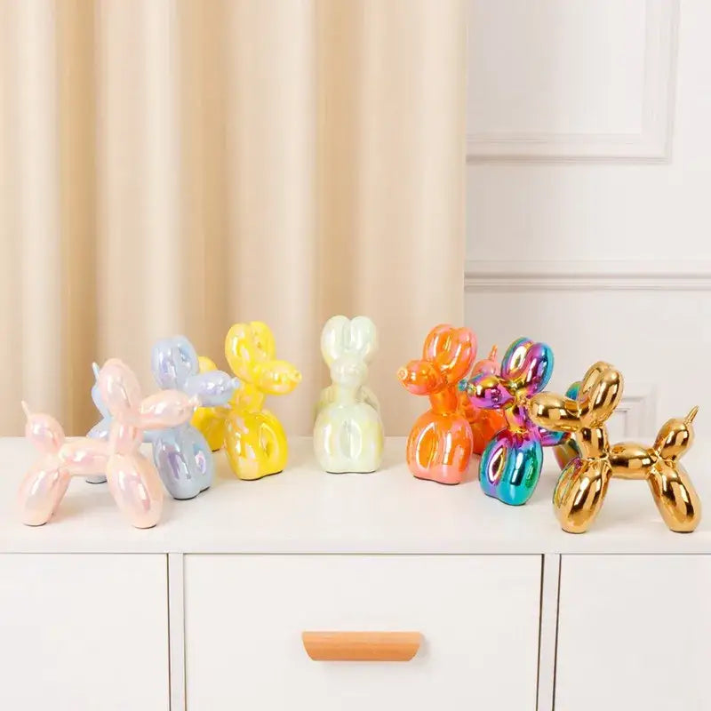 A collection of modern metallic decorbites ceramic balloon dog statues in pastel and iridescent colors for living room decor