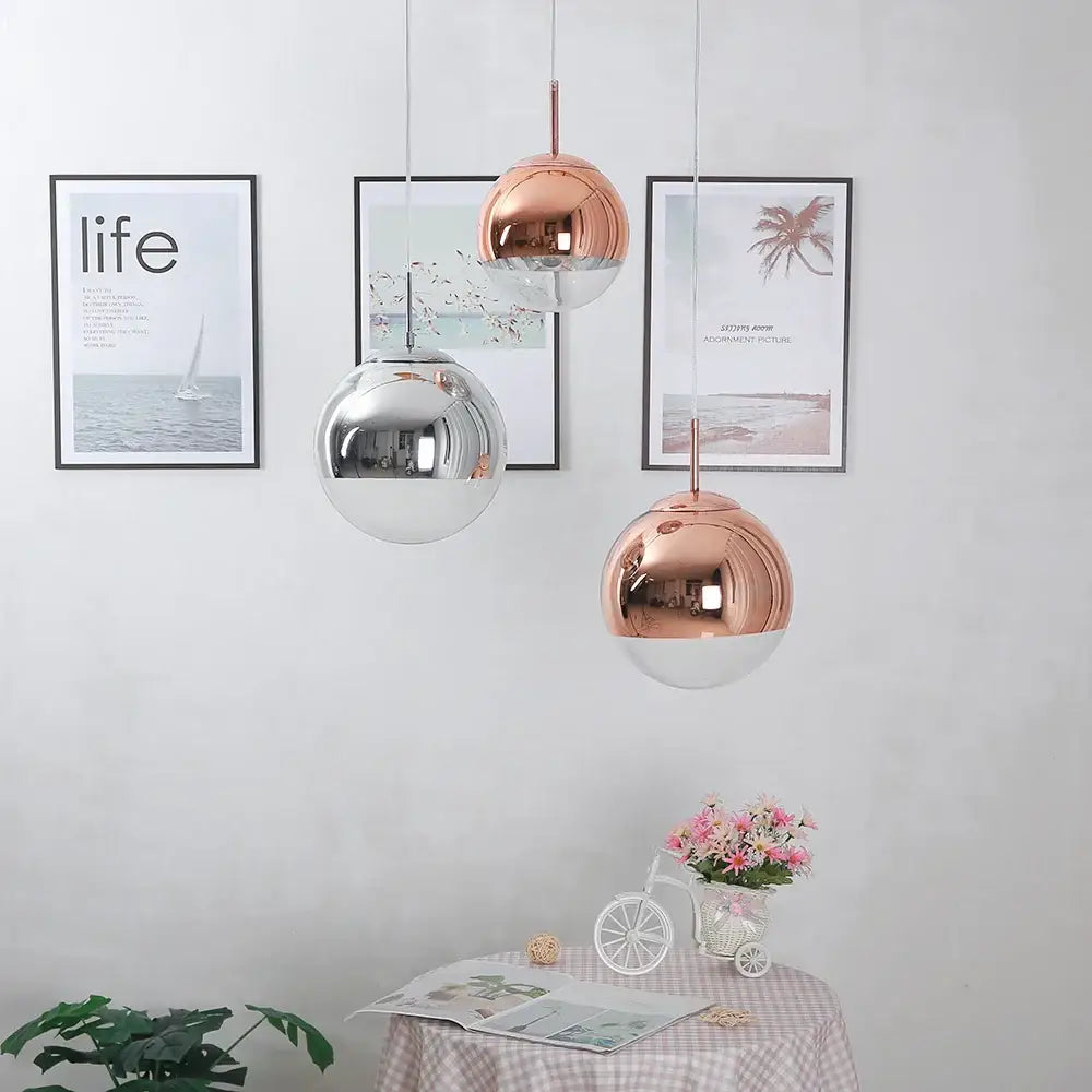Three metallic electroplate pendant lights in rose gold and silver tones for kitchen decor featuring decorbites glass ball