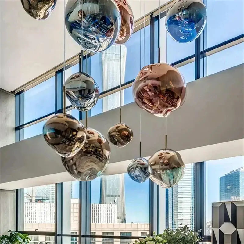Modern metallic glass pendant lights feature spherical reflective glass pendant lights in metallic finishes for dining rooms
