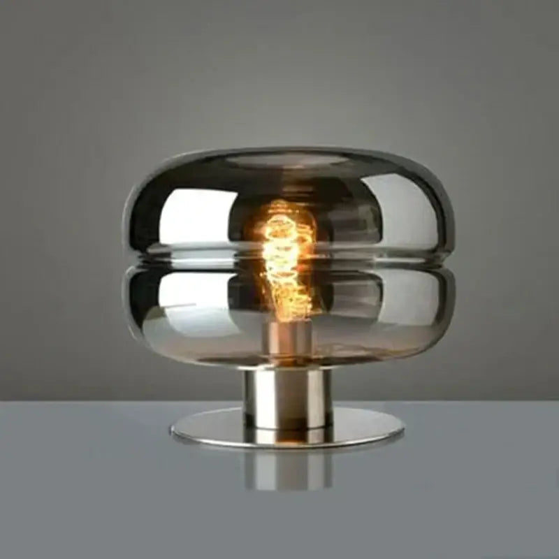 A modern metallic glass table lamp with dual-layered smoked glass dome and chrome base for elegant bedroom table lighting