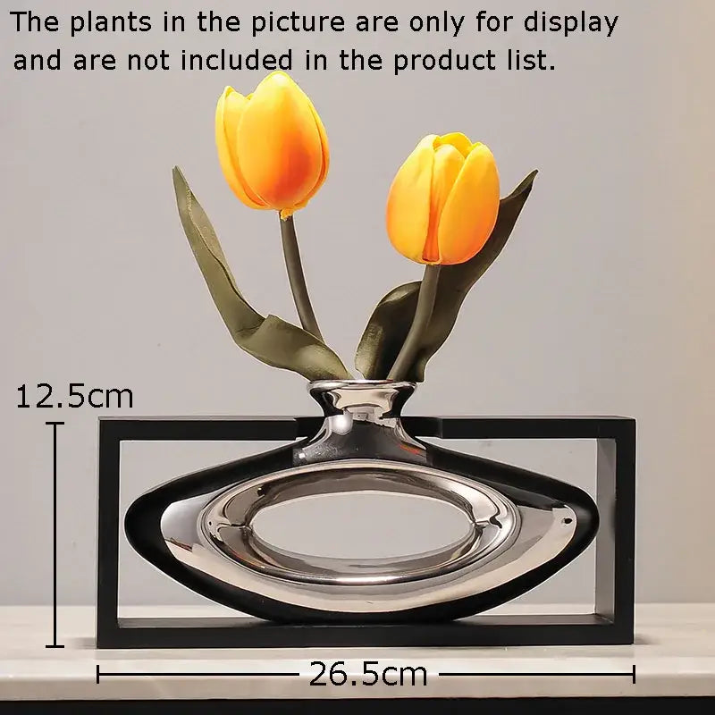 Modern silver-toned ceramic vase with sleek oval body and black rectangular frame featuring artificial flowers decorbites elegant square