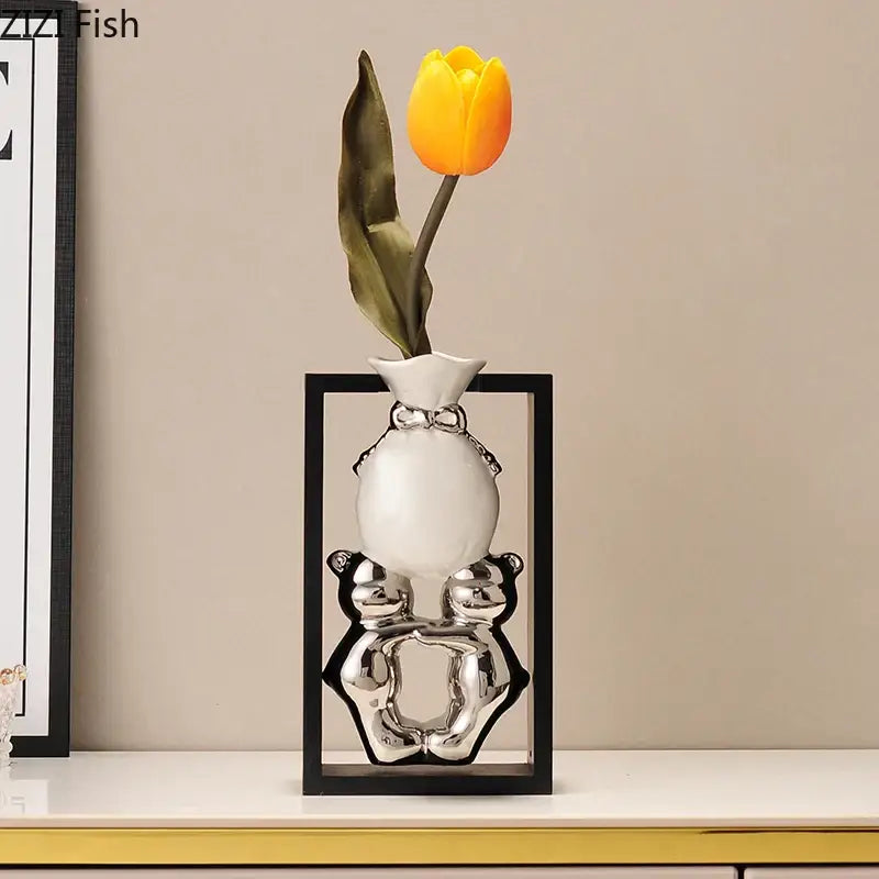 Modern metallic oval ceramic vase in white with silver bear design and decorative bow holding artificial flowers decorbites elegant square