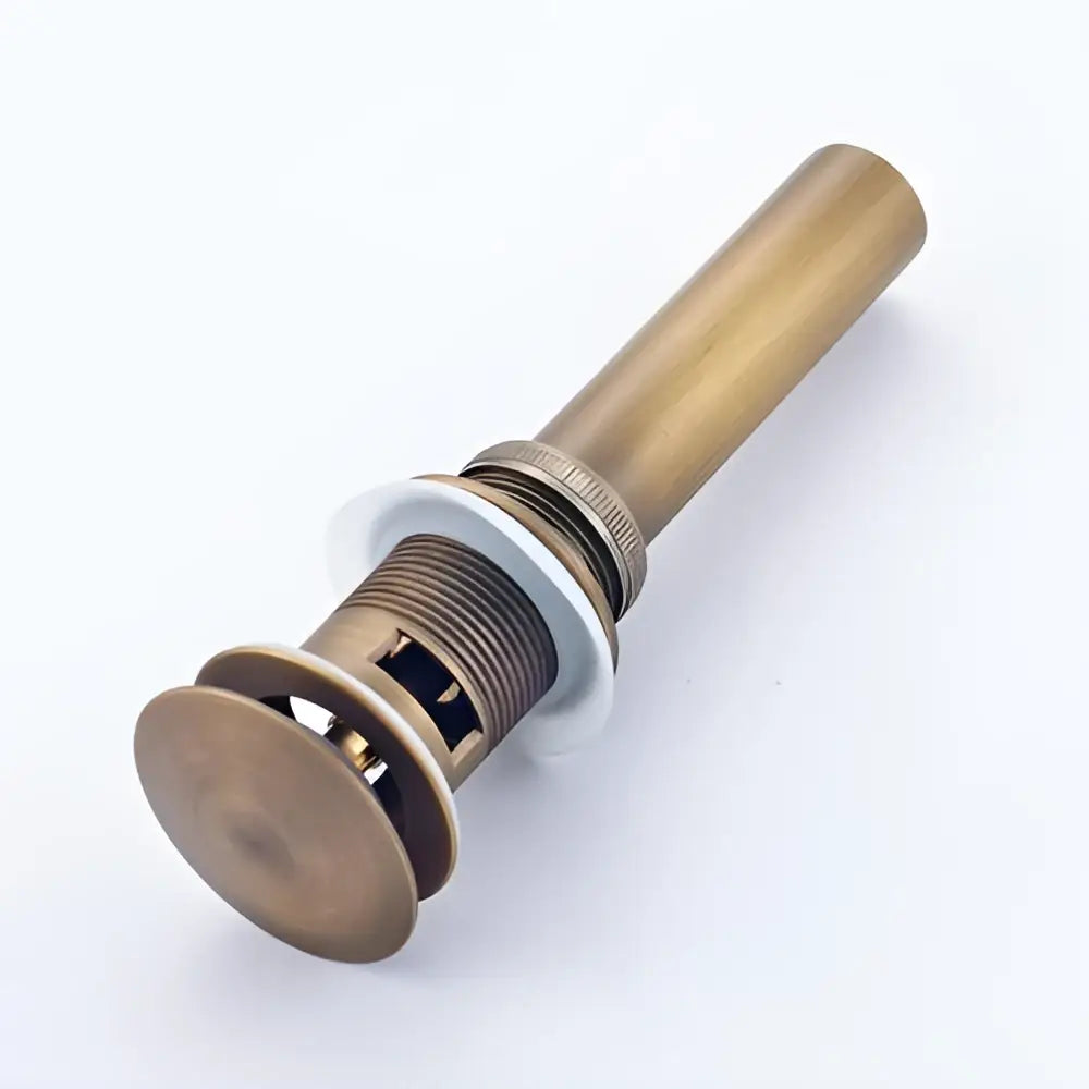 Antique brass modern metallic pop up bathroom basin waste with cylindrical body and circular flange for bathroom basin use