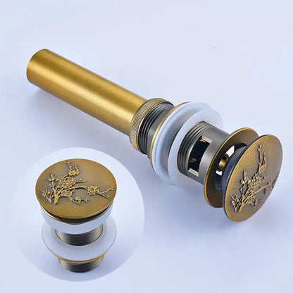Modern metallic pop up bathroom basin waste in gold-toned brass with intricate floral engraving for decorbites bathroom basin