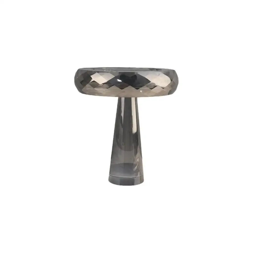 A sleek gray faceted glass fruit bowl with a modern design perfect for decorbites geometric glass dining room use