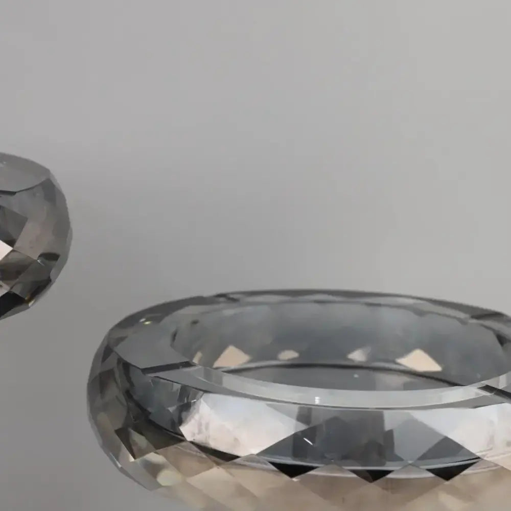 Faceted silver crystal ashtray with polished geometric design as a modern metallic decorbites geometric glass fruit bowl