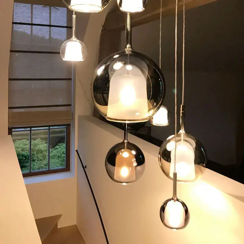 Modern metallic spherical designer glass chandelier with chrome fixtures and warm glowing interiors pendant light decorbites designer glass