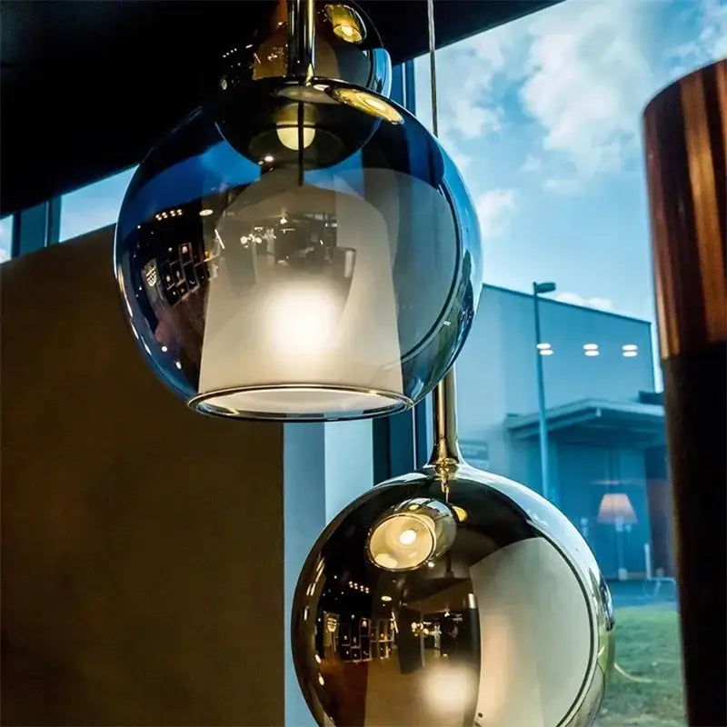 Two spherical glass pendant lights in dark blue and polished chrome by decorbites designer glass chandelier for dining rooms
