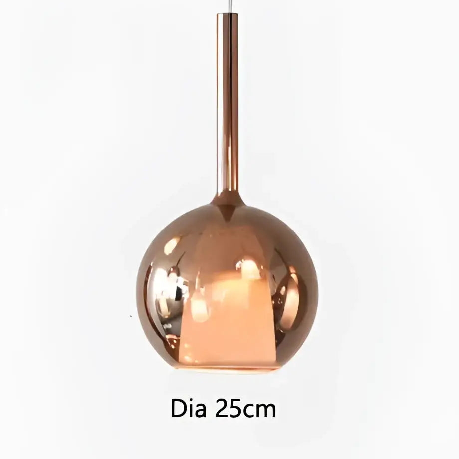 Copper-finished pendant light with sleek reflective spherical glass and cylindrical stem for modern dining room decorbites designer glass chandelier