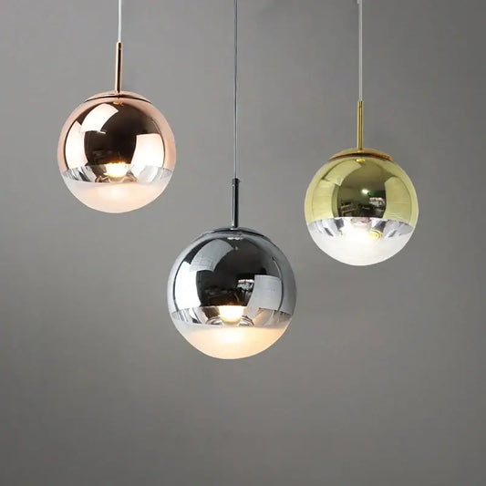 Modern metallic tri color ball pendant lights featuring rose gold chrome and brass finishes for living room use