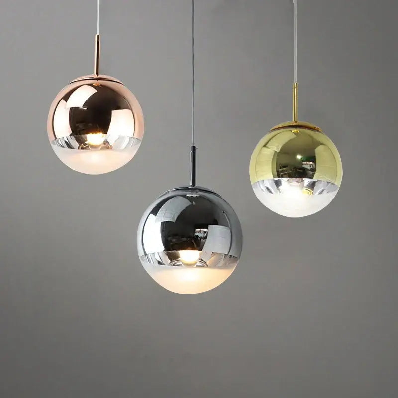 Modern metallic tri color ball pendant lights featuring rose gold chrome and brass finishes for living room use