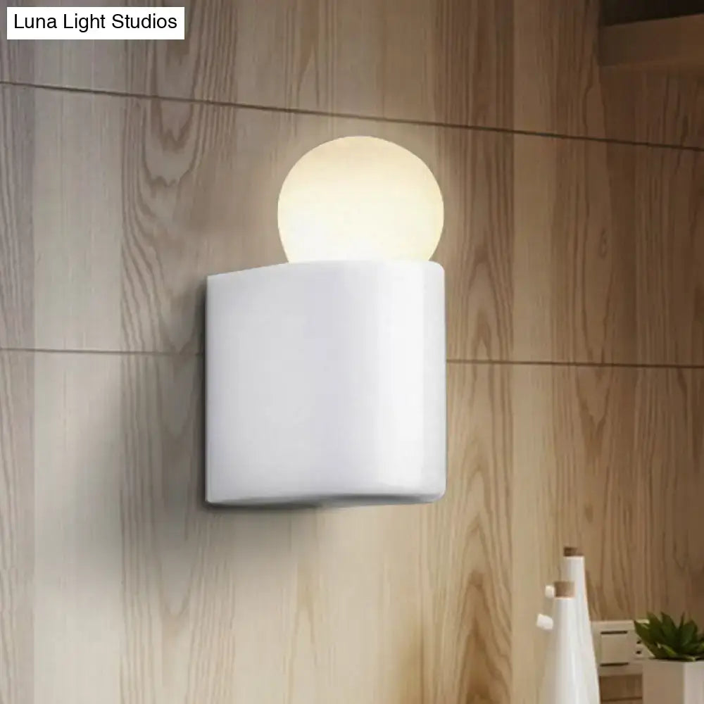 White square wall lamp with glowing milk glass spherical bulb suitable for small medium bedroom lighting