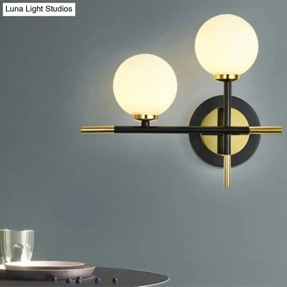 DecorBites™ DecorBites™ Modern Milk Glass Orb Sconce Wall Light - 2 Lights, Black and Brass Cross Design